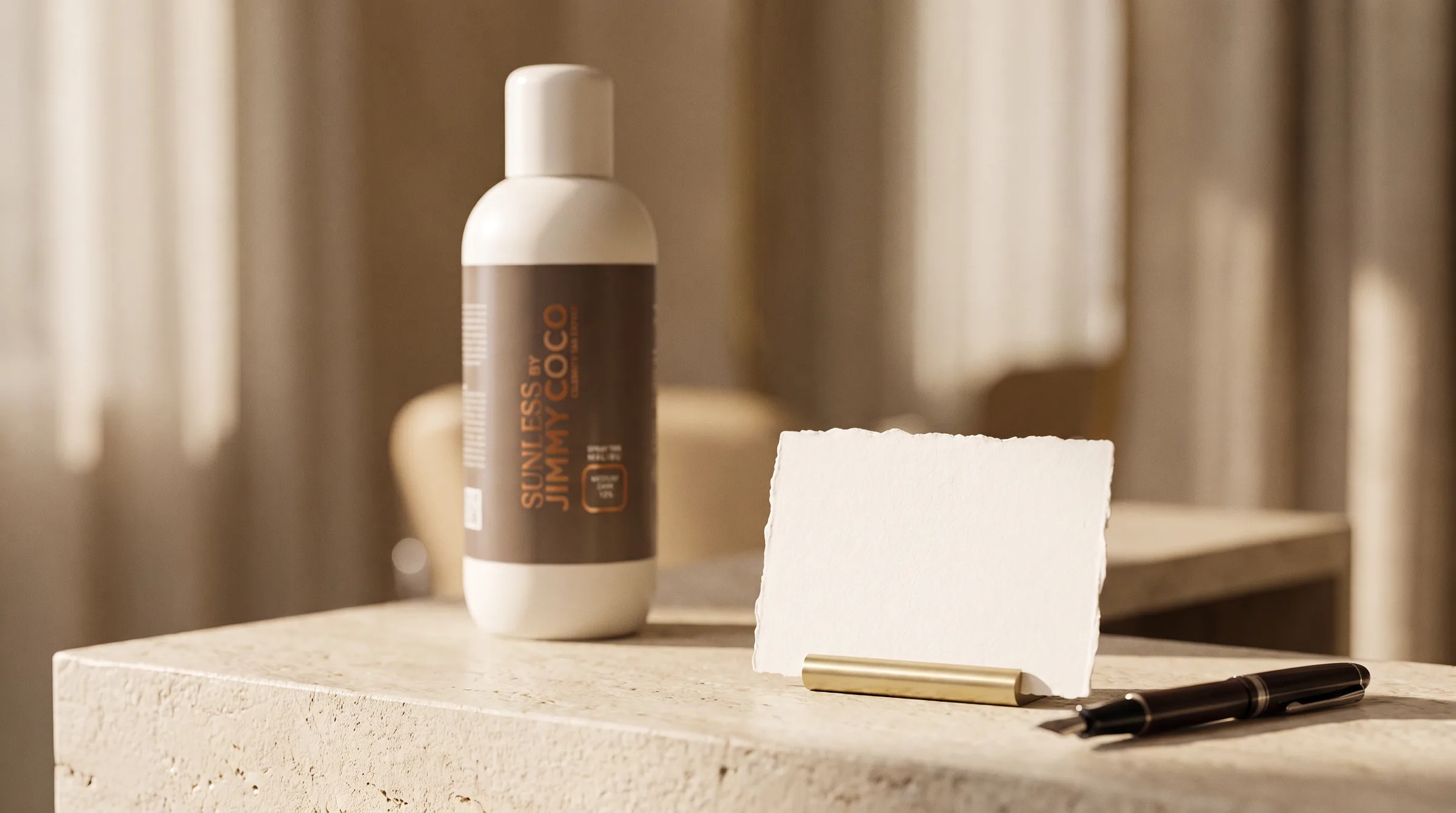 A blank price card in a brass holder on a salon counter, a pen beside it, a litre of professional solution behind.